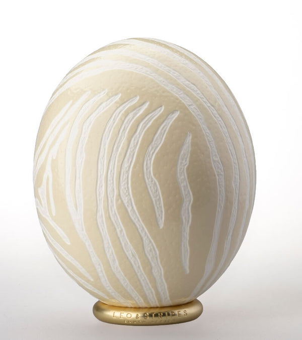 The Bold Zebra Carved Ostrich Egg Ornament from Leo & Stripes